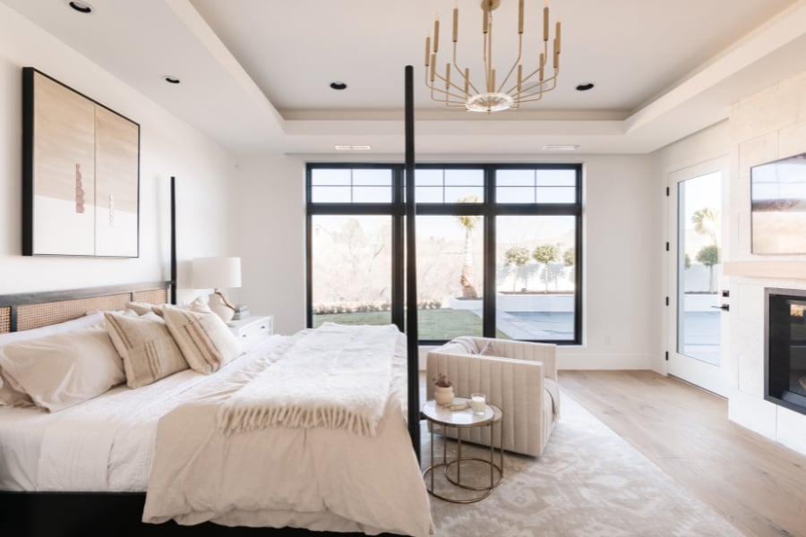 Elegant light bedroom with black frame 100 Series windows with grilles