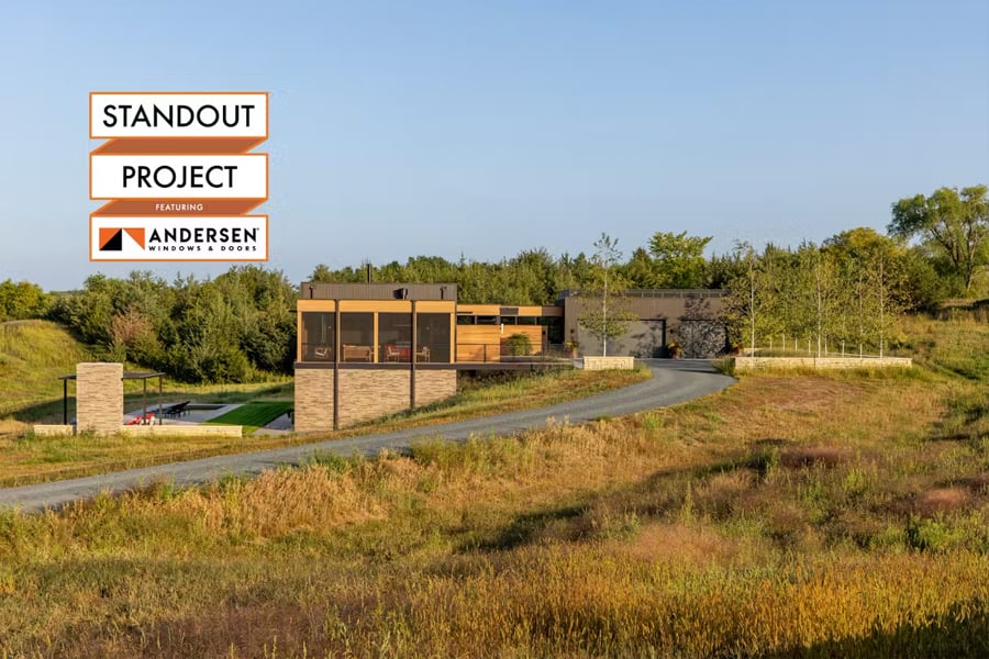 home on a hillside built with mixed materials- corrugated metal, cedar, and brick
