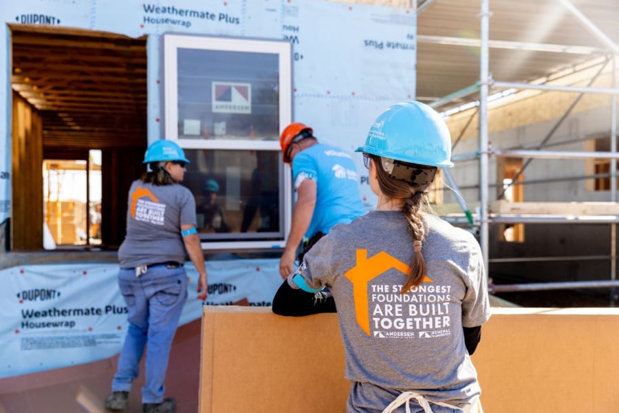 Volunteers on site installing windows