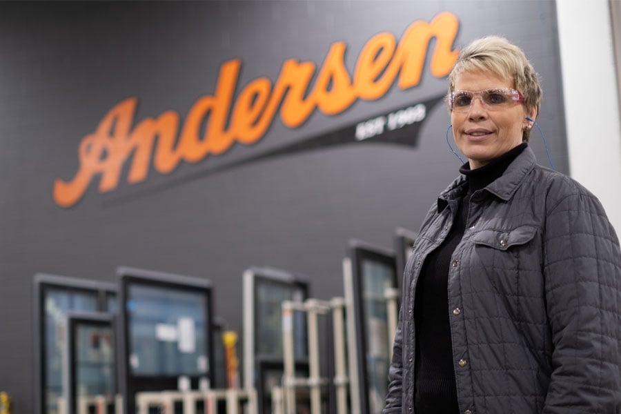 woman standing in manufacturing plant in front of andersen sign