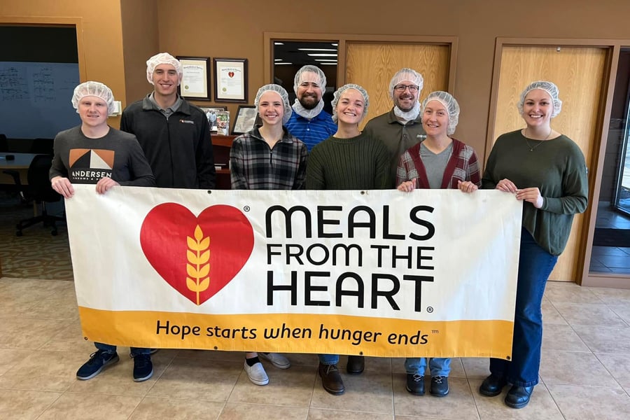 Volunteers in a kitchen helping prep meals