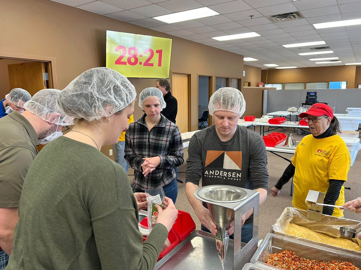 Volunteers in a kitchen helping prep meals