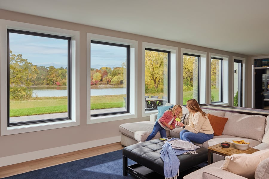 Young girl and mom in basement with large windows