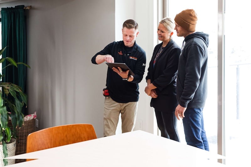 Certified Contractor showing homeowners designs on tablet