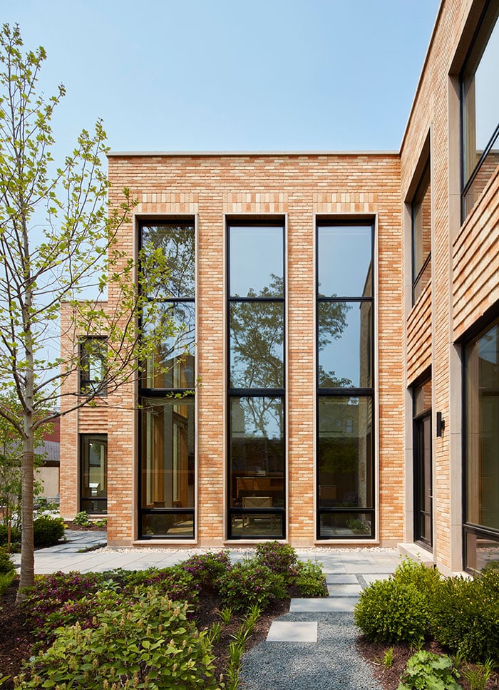 exterior shot of the living room, which features two-story E-Series Picture and Casement Windows.