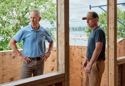 Two trade pros on a job site talking