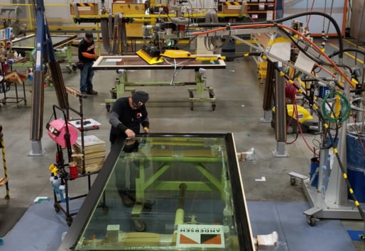 Employee working in factory on a Liftslide door
