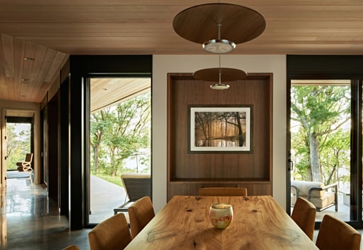A living room with floor-to-ceiling windows and polished concrete floors.