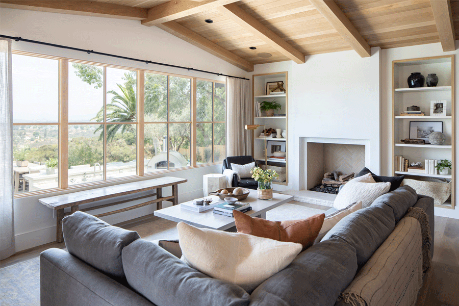 A wall of white oak windows gives a warm but modern look to a living room.