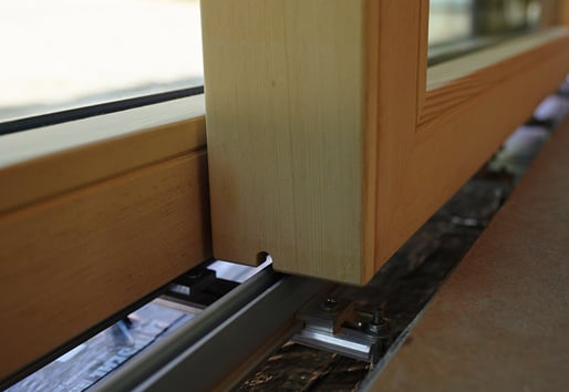 A close-up showing the tight tolerance between the concrete floor and the Liftslide Door’s panel.