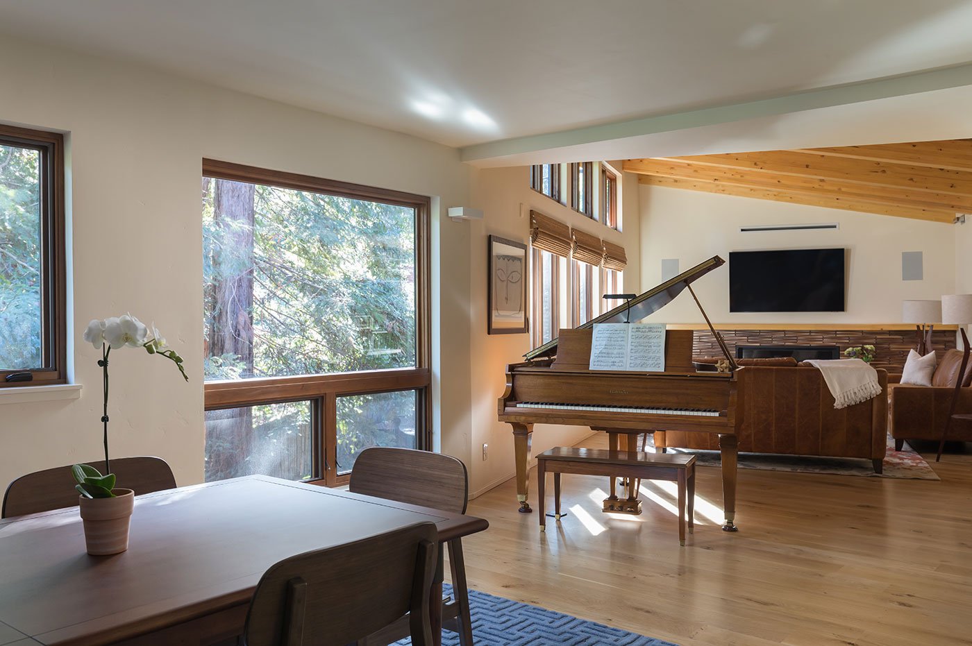 A dining room and living room awash in natural light.