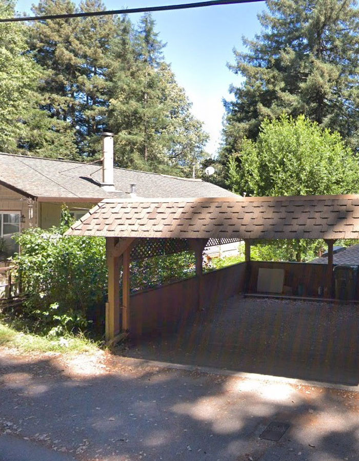 a before picture of the street-facing carport and stairs that constituted an entrance to the home.