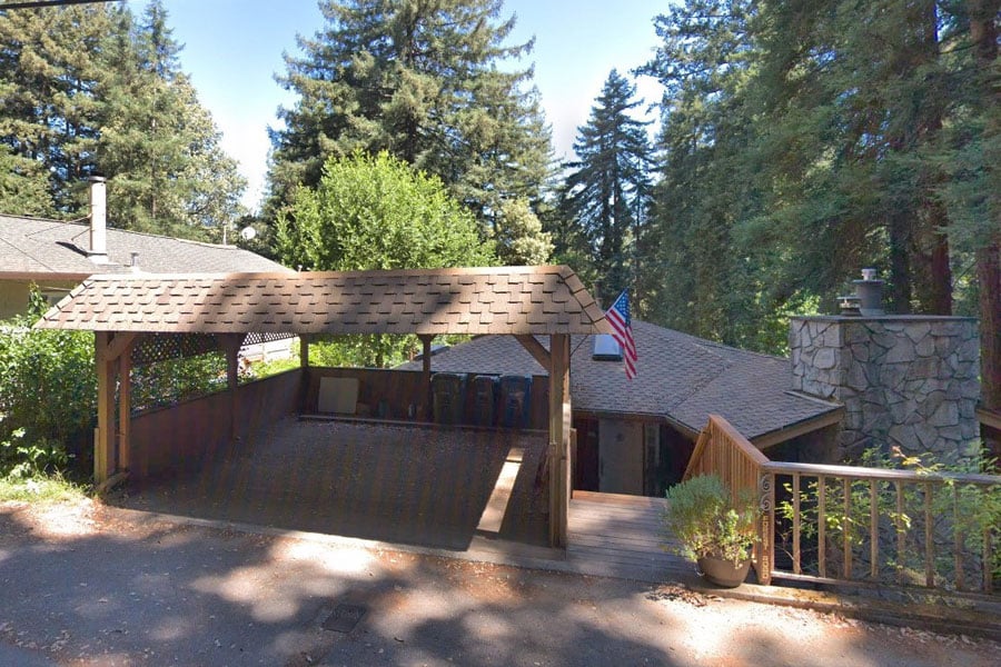 a before picture of the street-facing carport and stairs that constituted an entrance to the home.