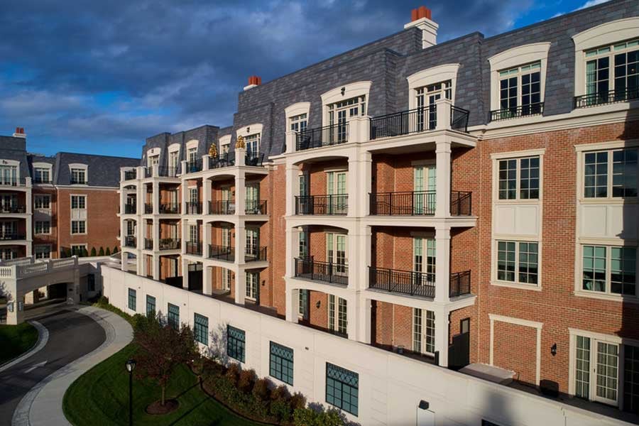 Ritz-Carlton Residences building from outdoors showcasing brick building balcony under blue sky