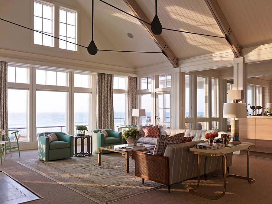 Living room with floor to ceiling windows overlooking the ocean