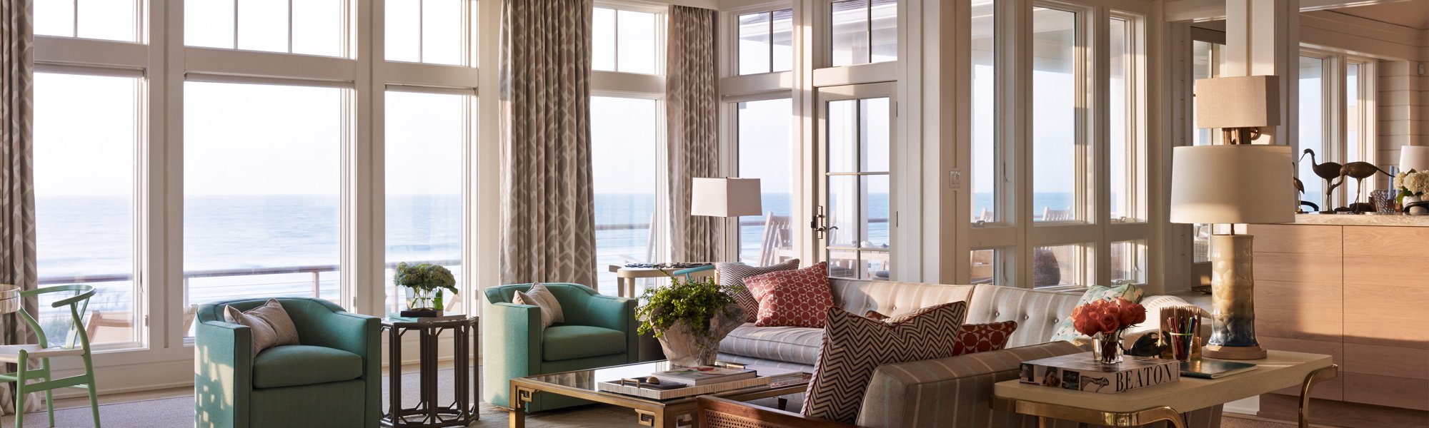 Living room with floor to ceiling windows overlooking the ocean