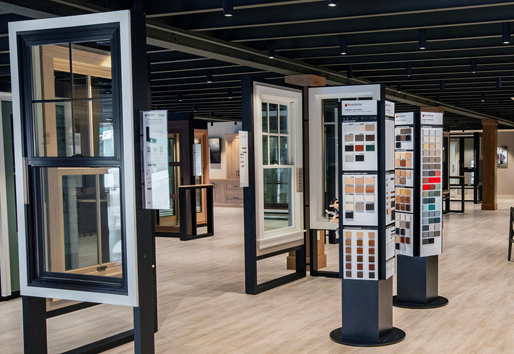 Andersen Windows showroom with black and white double-hung windows and color swatches