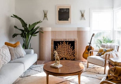 living room with unique fireplace and Andersen white framed windows