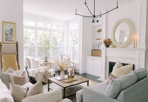 interior view of living room with fireplace with white framed Andersen windows