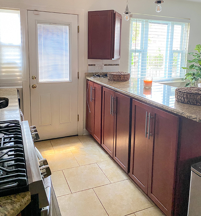A front door after a replacement in a kitchen setting (shown on the right) and a before picture of the old front door (show on the left).