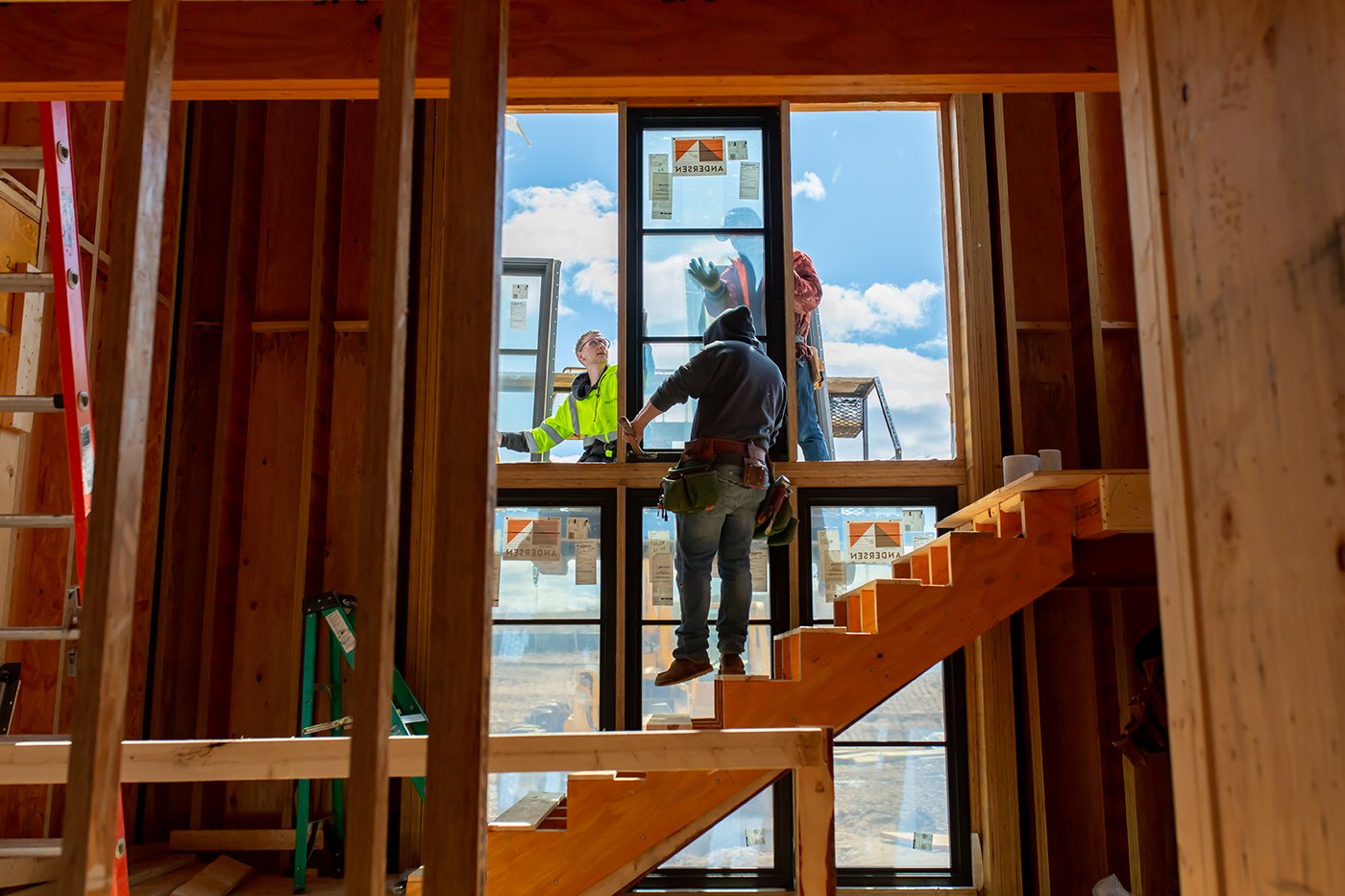 New windows being installed over a stair in a new construction home.