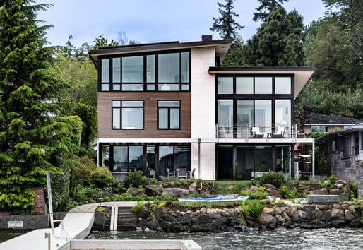 Modern home with large windows overlooking the waterfront