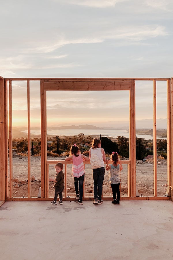 two people looking through framed construction of large patio door