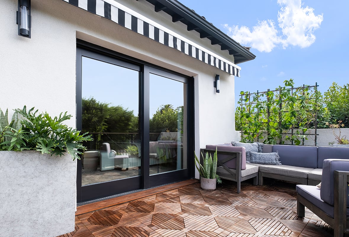 A balcony connected to a Spanish-style home via a two-panel Andersen pocketing MultiGlide Door.