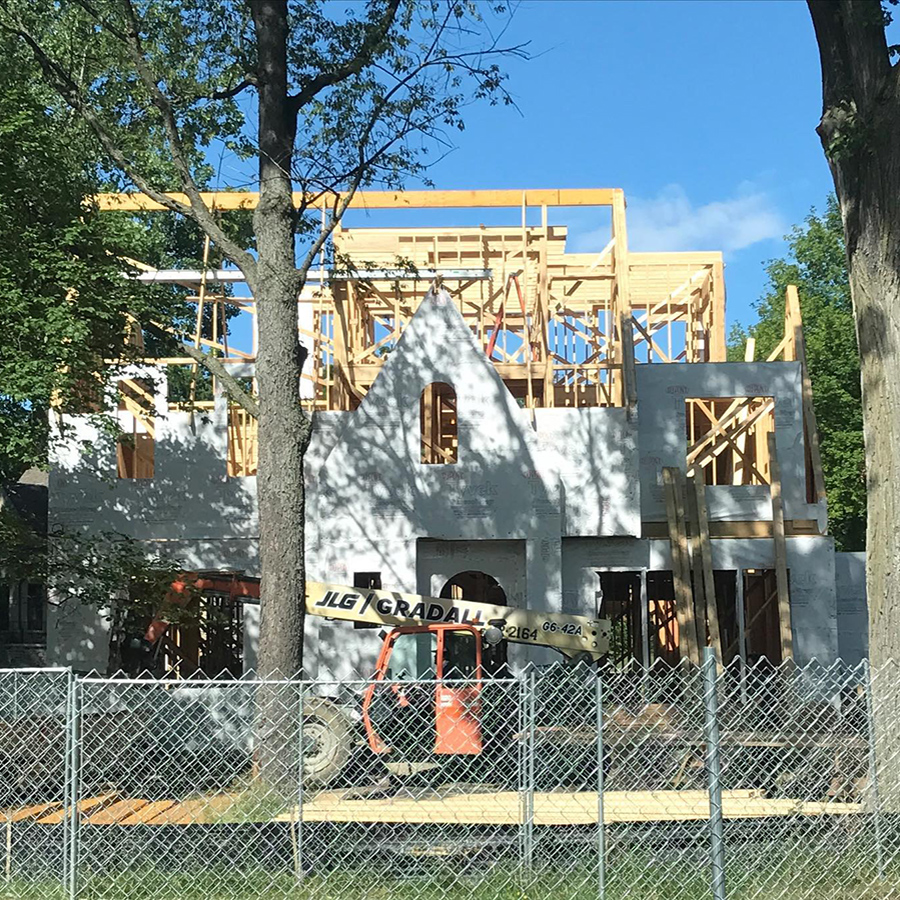 A before picture of a home under construction and an after image of a new construction Tudor-style home.