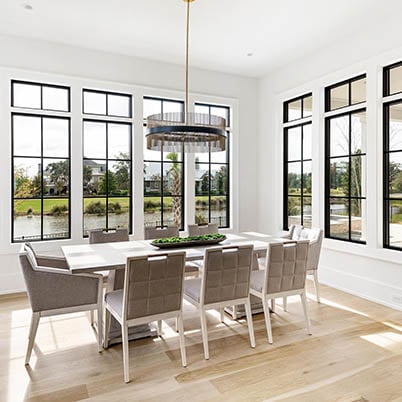 Light and bright dining room with black windows