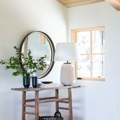 entry way with white walls and light wood frames andersen e series window with panes