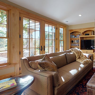 Andersen Windows Project Iverson Home Living Space featuring Wood A-Series Double-Hung Windows and Hinged Patio Door