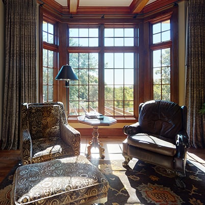 Andersen Windows Project Iverson Home Sitting Area Featuring Wood A-Series Casement and Picture Windows