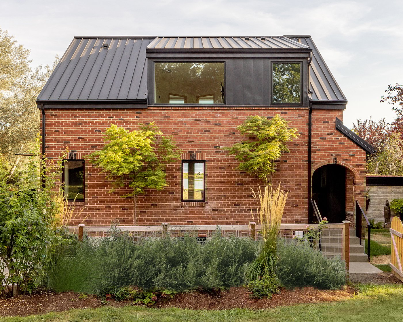 The back of a brick cottage with E-Series casement and picture windows.