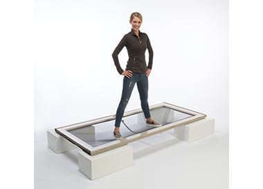 woman standing on andersen storm door to show strength of door