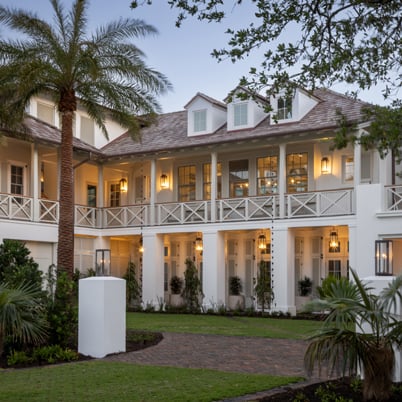 A coastal home with a large, covered porch and white A-Series windows and doors.