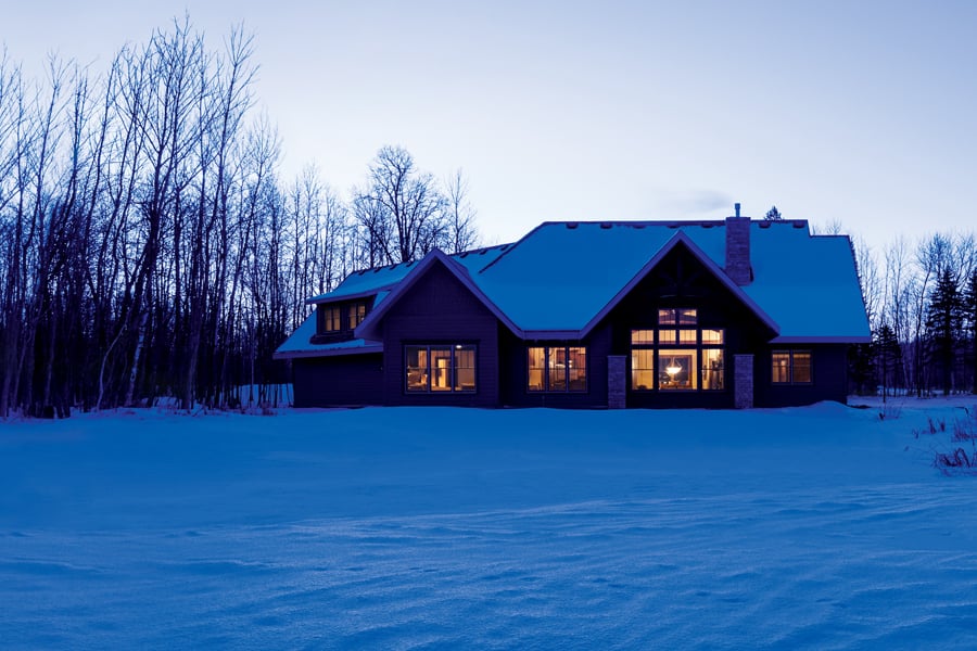 Home set back in the woods in winter with 400 Series windows