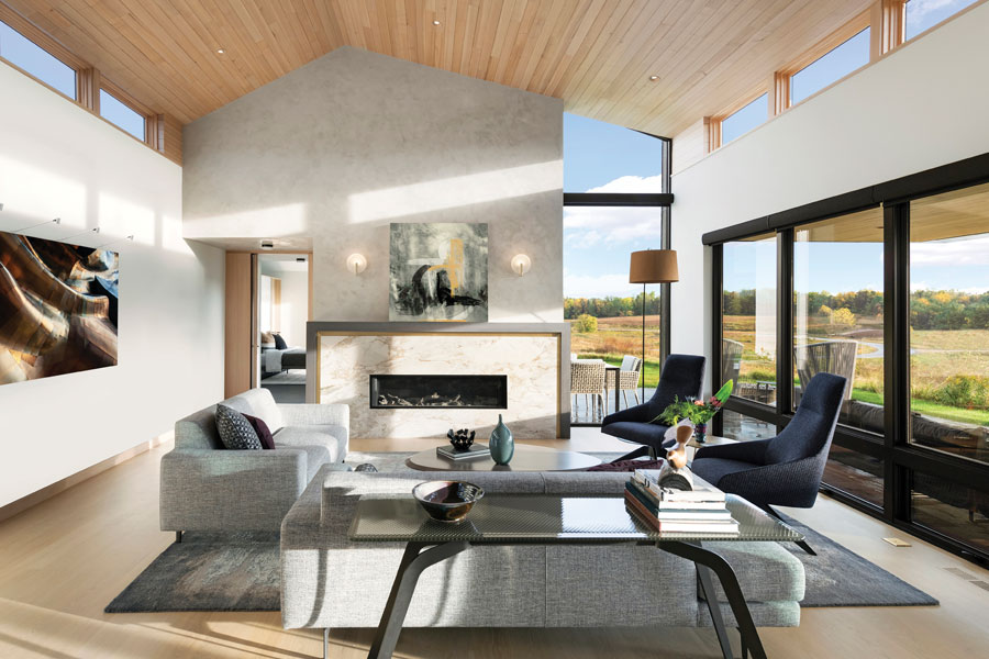A living room with clerestory windows on both sides and floor-to-ceiling windows facing the backyard.