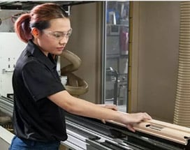woman using saw machine