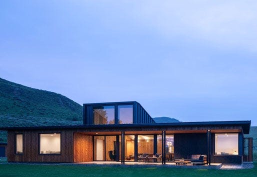 exterior view of modern home at dusk with lights on