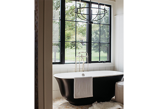 Freeman custom homes Large black windows with grilles over freestanding bathtub in bathroom