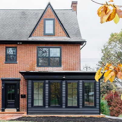 red brick home with black framed Andersen windows