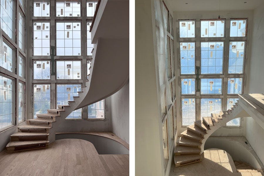 Two walls of Andersen windows encase a curved staircase in Alicia L’Esperance’s home creating a stair tower