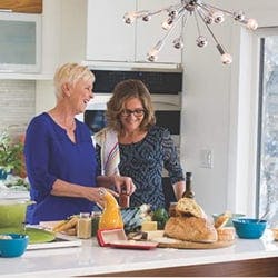 older woman and younger woman in kitchen cooking in front of andersen door