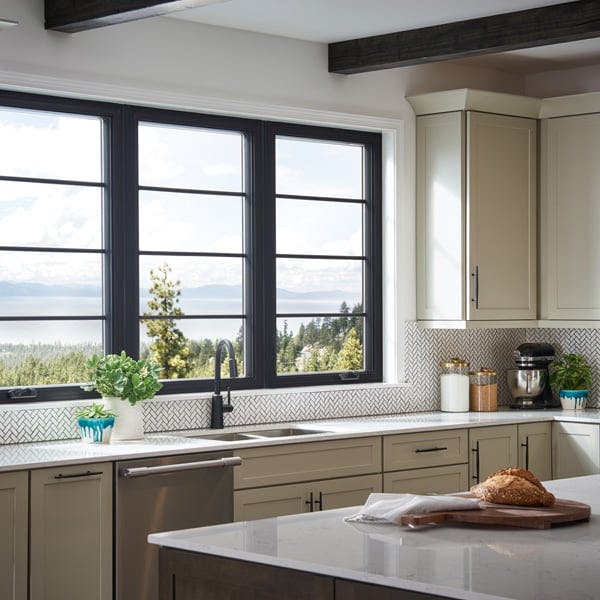 Kitchen with black interiors and hardware with 100 series casement Andersen Windows
