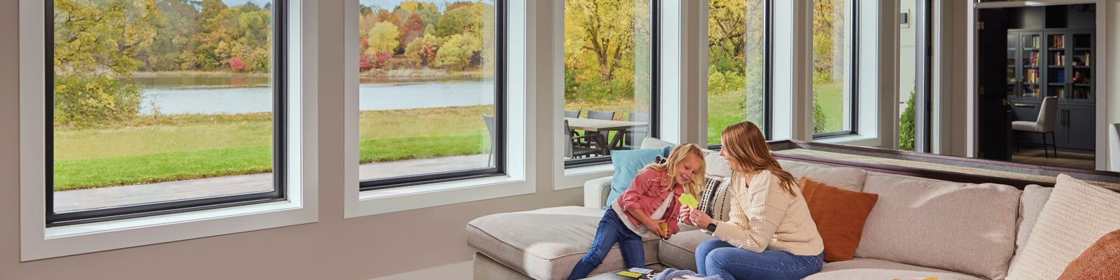 Young girl and mom in basement with large windows