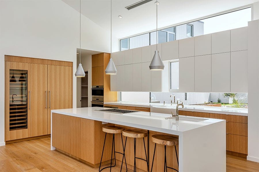 Modern white and wood kitchen with white interior Andersen Aluminum windows